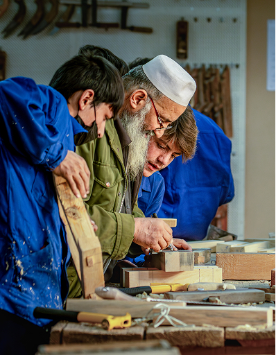 Calligraphy and craft pieces displayed on a wall