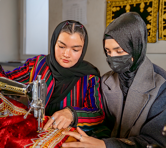 Hands sculpting clay figure with tools nearby